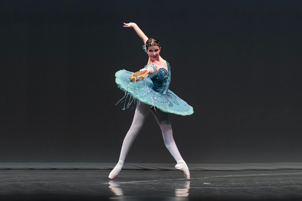 Woman in a blue dress in a ballet position