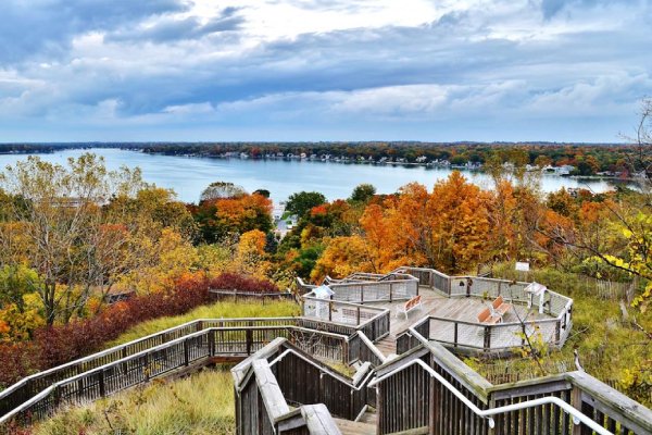 wooden stairs on a hill overlooking a lake